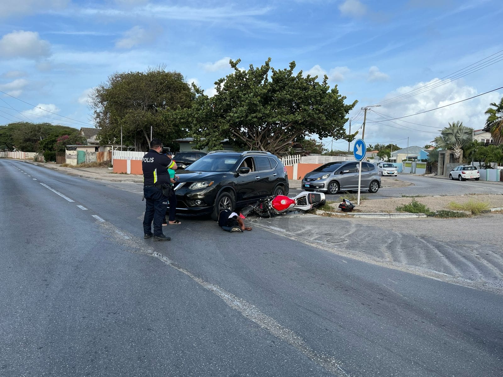 Motorcycle trapped under car after collision | English - 24ora